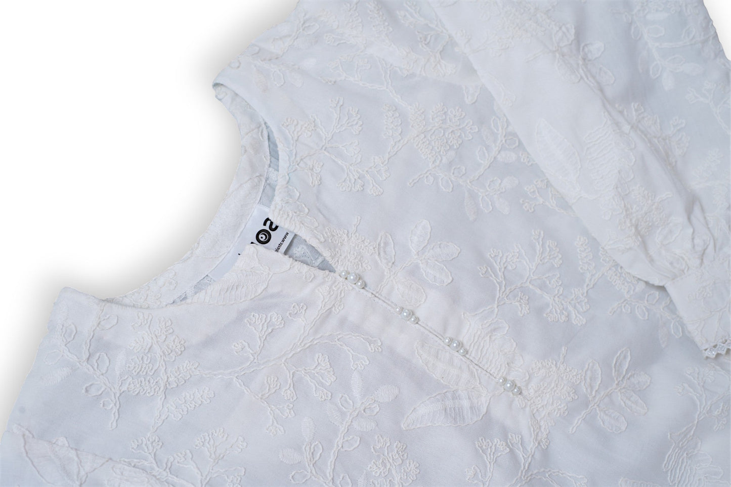 White chikankari cotton kids kurti with embroidered texture, full sleeves, lace-trim hem, and round neckline — handcrafted Pakistani kids clothing.